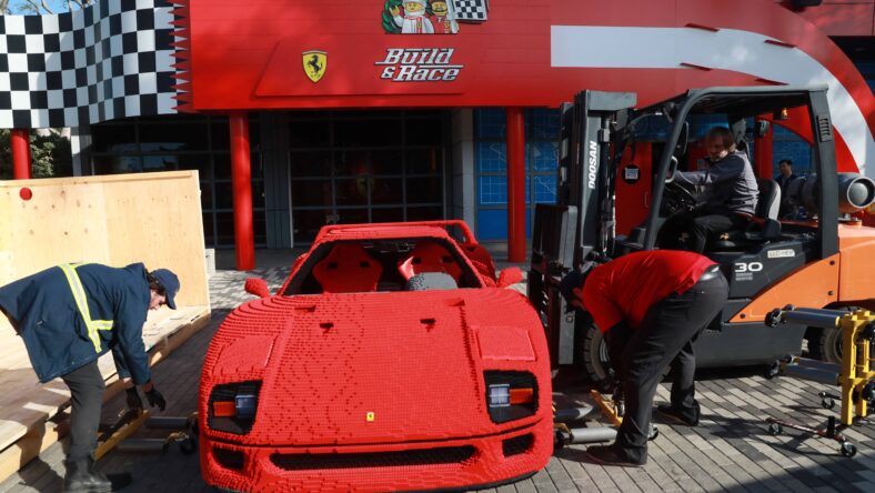This one-of-a-kind life-size Lego Ferrari is set to go on display at LEGOLAND in California. The red Ferrari F40 car is made out of more than 358,000 Lego pieces and weighs more than 3,000 pounds. It took a team of designers and builders more than 1,800 hours to develop and more than 1,900 hours to construct the high-performance ultra-luxury sports car. Resembling the actual F40 Ferrari, the toy brick version is similar in size at 14 feet in length, more than six feet wide, 4 feet tall and a wheelbase at 8 feet. Visitors can enjoy it as part of the resort's new attraction, LEGO Ferrari Build and Race, opening on May 12, 2022 at the Carlsbad theme park. The model will be featured in the garage area. "Future builders, drivers and enthusiasts will get a chance to sit inside, take pictures and most of all, be inspired by the life-size LEGO vehicle," a spokesperson said. The garage is one of three interactive zones which also includes the build and test area, and digital racetrack for guests to digitally race their own LEGO Ferrari against other cars for the fastest lap. The new attraction places guests in the driver's seat as they use their creativity and imagination to build, test and race. Editorial usage. Credit Courtesy of LEGOLAND California Resort/MEGA. 28 Apr 2022 Pictured: The Ferrari goes on display. Photo credit: LEGOLAND California Resort/MEGA TheMegaAgency.com +1 888 505 6342 (Mega Agency TagID: MEGA852104_007.jpg) [Photo via Mega Agency]